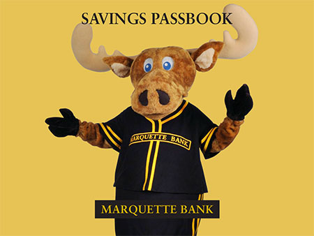 Large image of Marty the moose raising his hands in front of yellow background with Marquette Bank on bottom of image and Savings Passbook title on top of image.