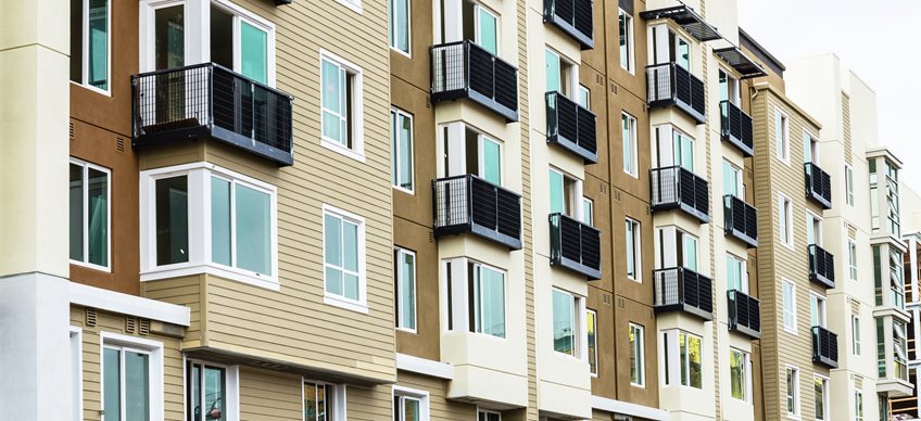 Image of high rise apartment building in cream and brown tones