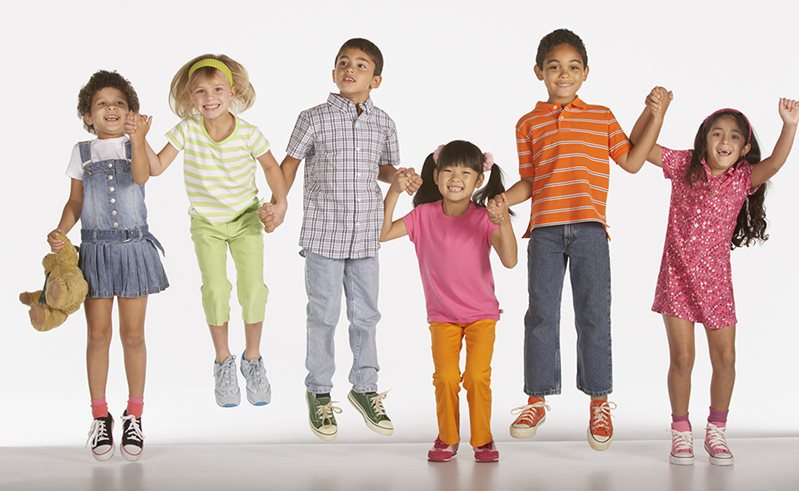 Group of jumping happy kids holding hands